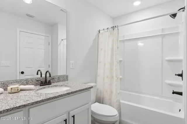 a bedroom with a bed and a ceiling fan