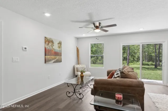 a living room with furniture and kitchen view