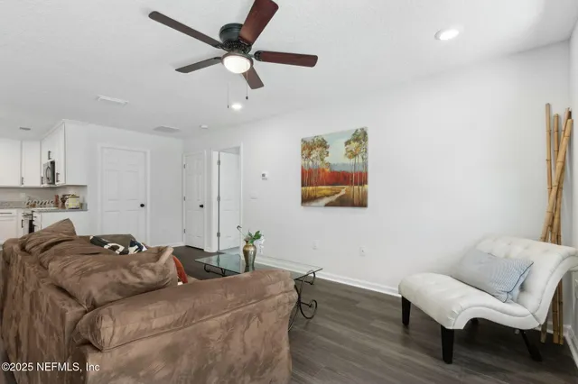 a dining room with furniture a chandelier and wooden floor