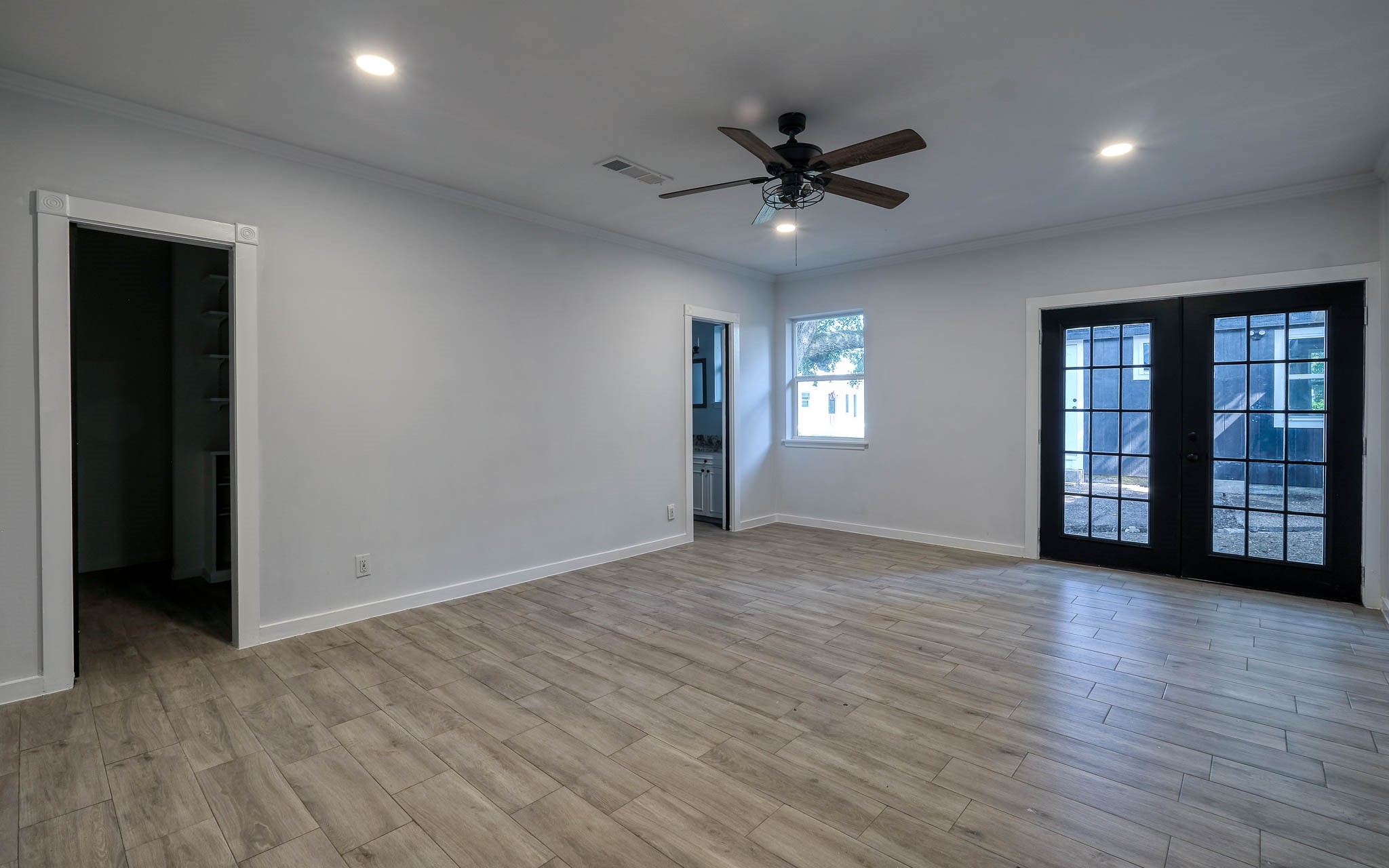 20515 Kickapoo Road Waller, TX 77484 - Photo 17 of 50 a view of an empty room with window and wooden floor