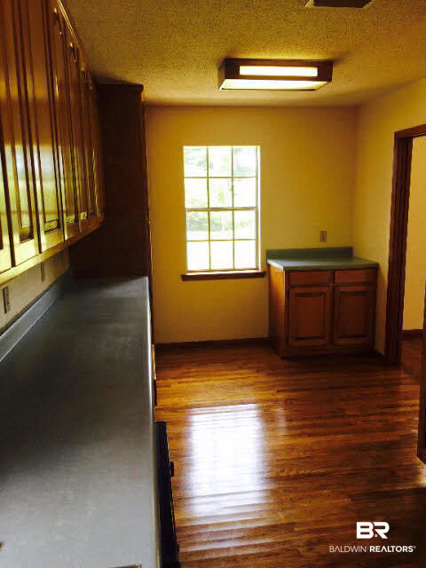 39660 Hannis Williams Road Bay Minette, AL 36507 - Photo 8 of 32 For Sale: 39660 Hannis Williams Road, Bay Minette, AL 36507 Kitchen with wood floors