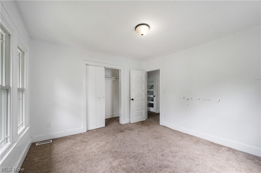 371 Merriman Road Akron, OH 44303 - Photo 22 of 27 Carpeted room with white walls, a multi-pane window, and a flush-mount ceiling light