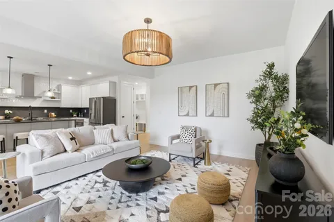 a living room with furniture and kitchen view