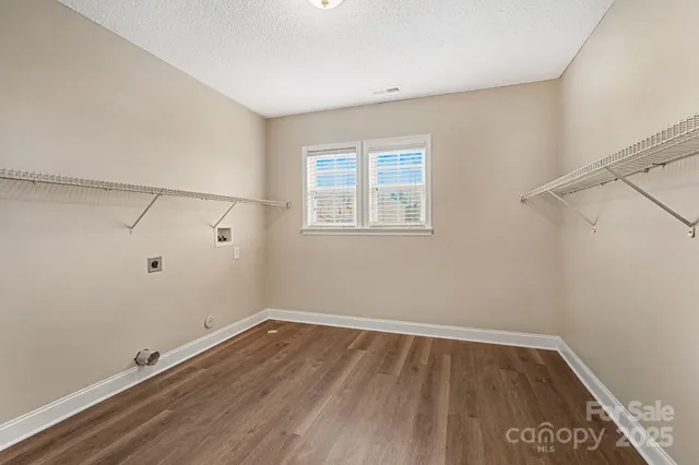a view of a room with wooden floor and cabinet