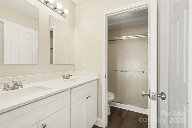 a bathroom with a granite countertop sink toilet and shower