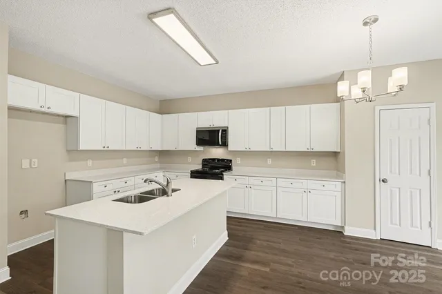 a kitchen with cabinets a sink and appliances
