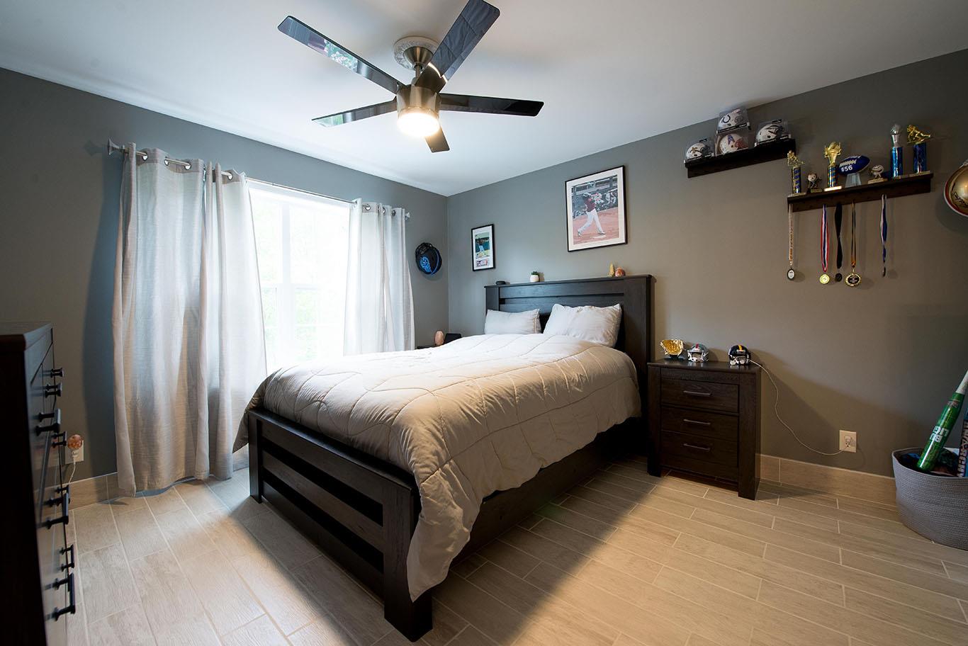 16 Kukas Road Monticello, NY 12701 - Photo 35 of 47 a bed sitting in a bedroom next to a window and a chandelier