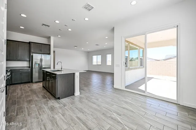 a kitchen with stainless steel appliances kitchen island wooden cabinets and granite counter tops