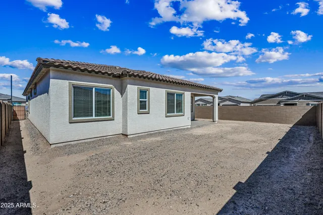 a view of house with backyard