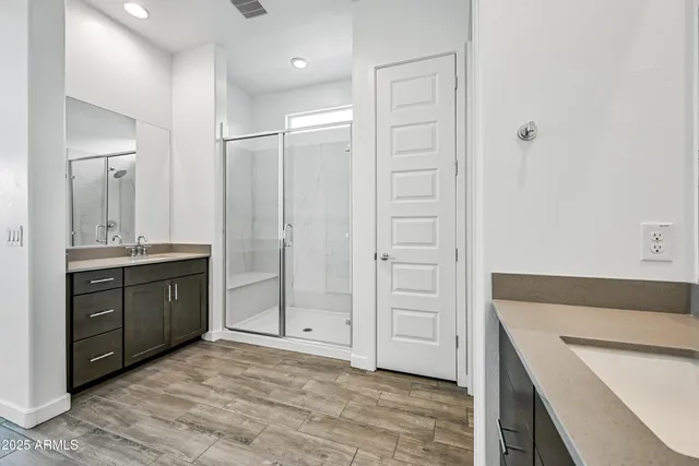 a bathroom with a granite countertop sink a mirror and a bathtub