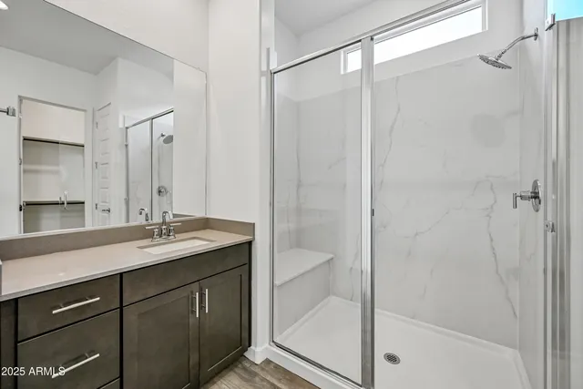 a bathroom with a granite countertop sink mirror and double
