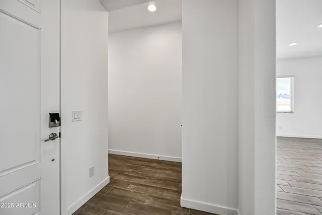 a view of a hallway with wooden floor