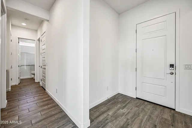 a view of a hallway with wooden floor