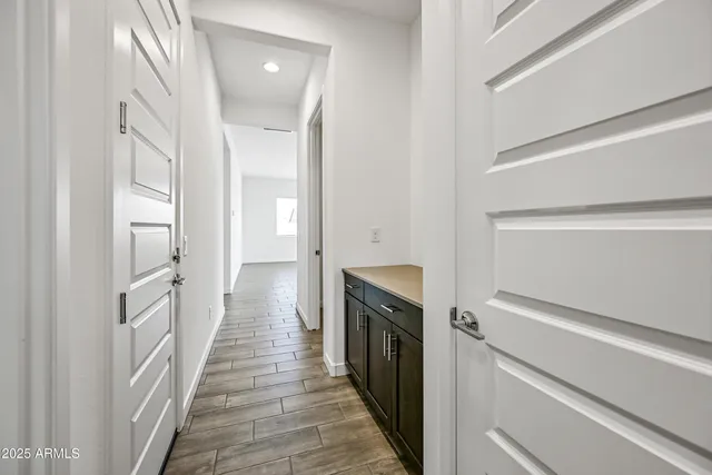 a view of a hallway with wooden floor and staircase