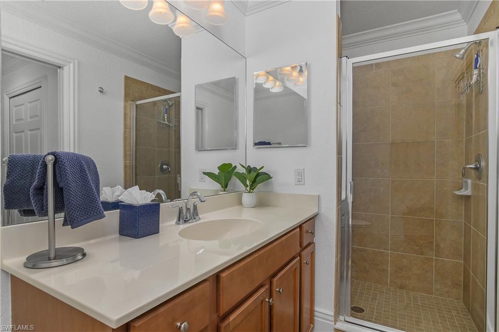 9554 Trevi Court, Unit 4727 Naples, FL 34113 - Photo 19 of 50 a bathroom with a shower sink and mirror