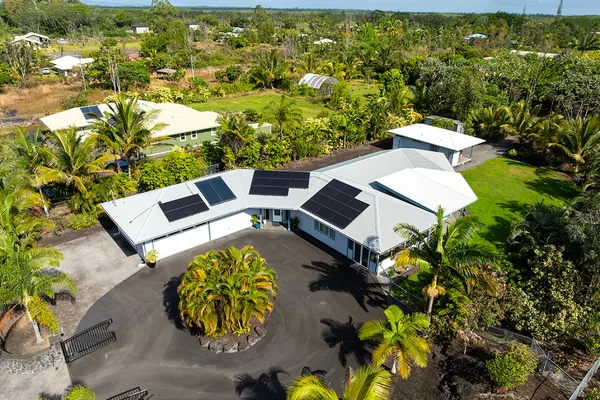 an aerial view of a house with yard swimming pool and outdoor seating