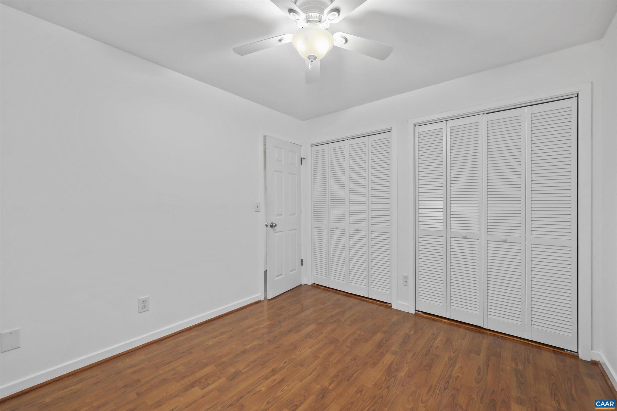 1250 Maple View Drive Charlottesville, VA 22902 - Photo 6 of 25 a view of a room with wooden floor and a ceiling fan