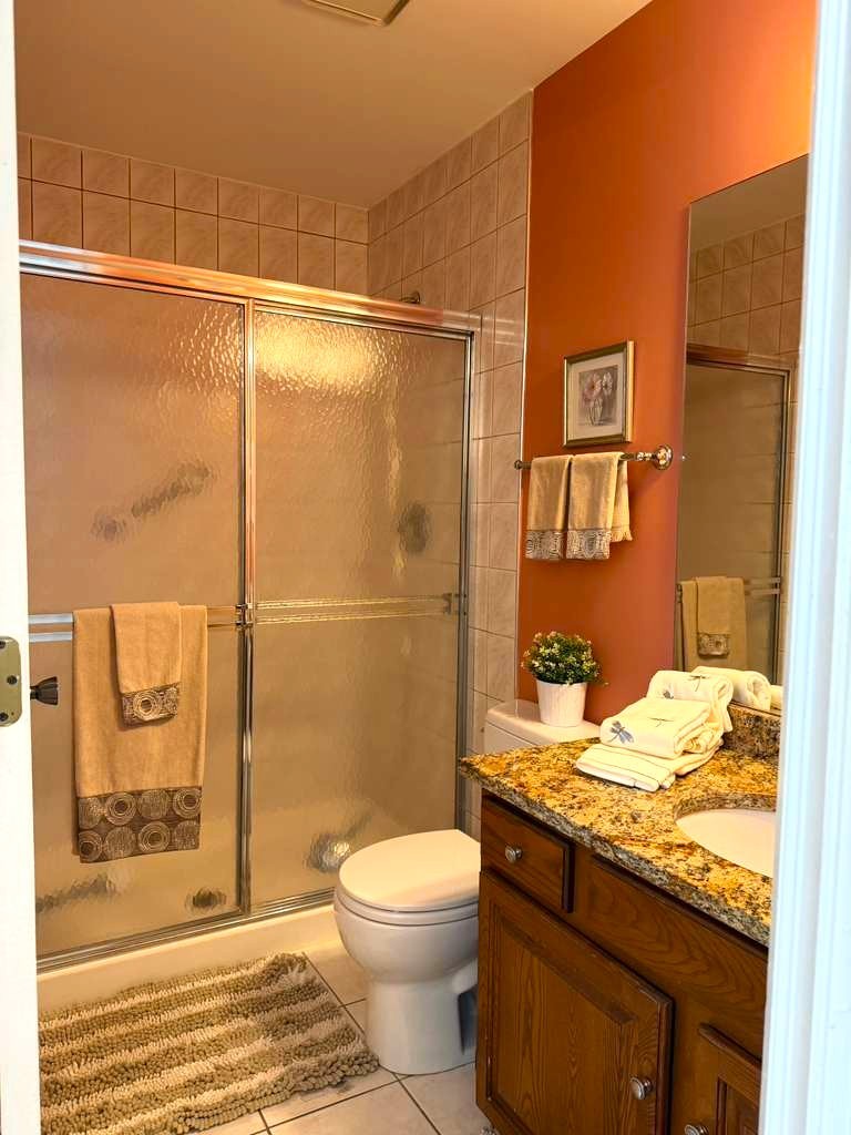 1410 Tulip Court, Unit D2 Wheeling, IL 60090 - Photo 11 of 30 a bathroom with a granite countertop sink toilet and shower