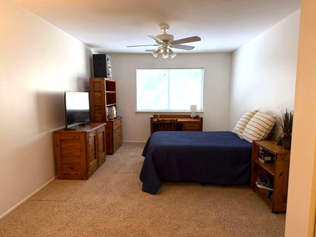1410 Tulip Court, Unit D2 Wheeling, IL 60090 - Photo 13 of 30 a bedroom with a bed and a flat tv screen on a dresser