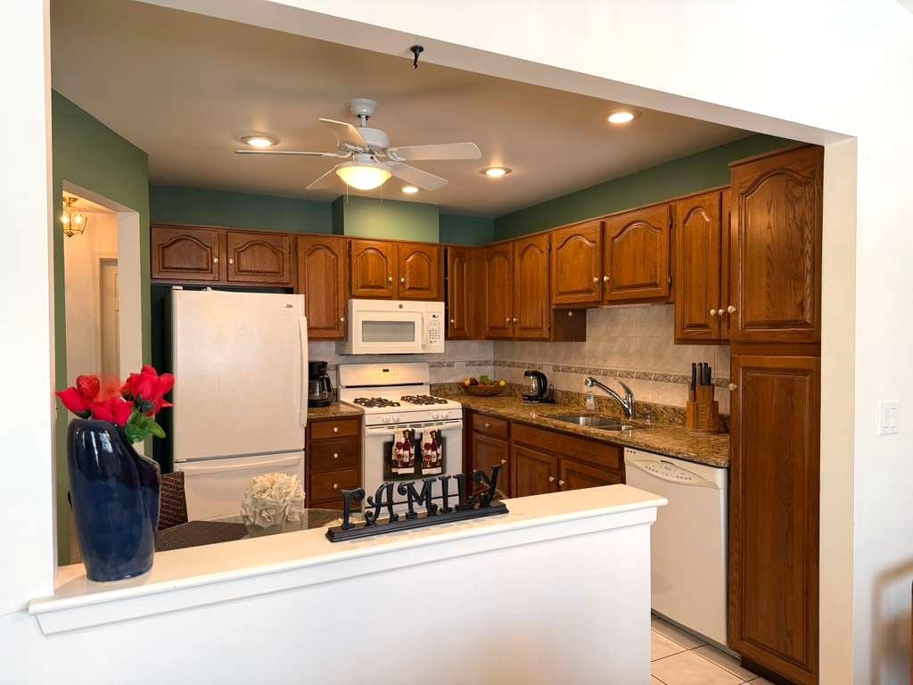 1410 Tulip Court, Unit D2 Wheeling, IL 60090 - Photo 2 of 30 a kitchen with stainless steel appliances granite countertop a refrigerator and a stove