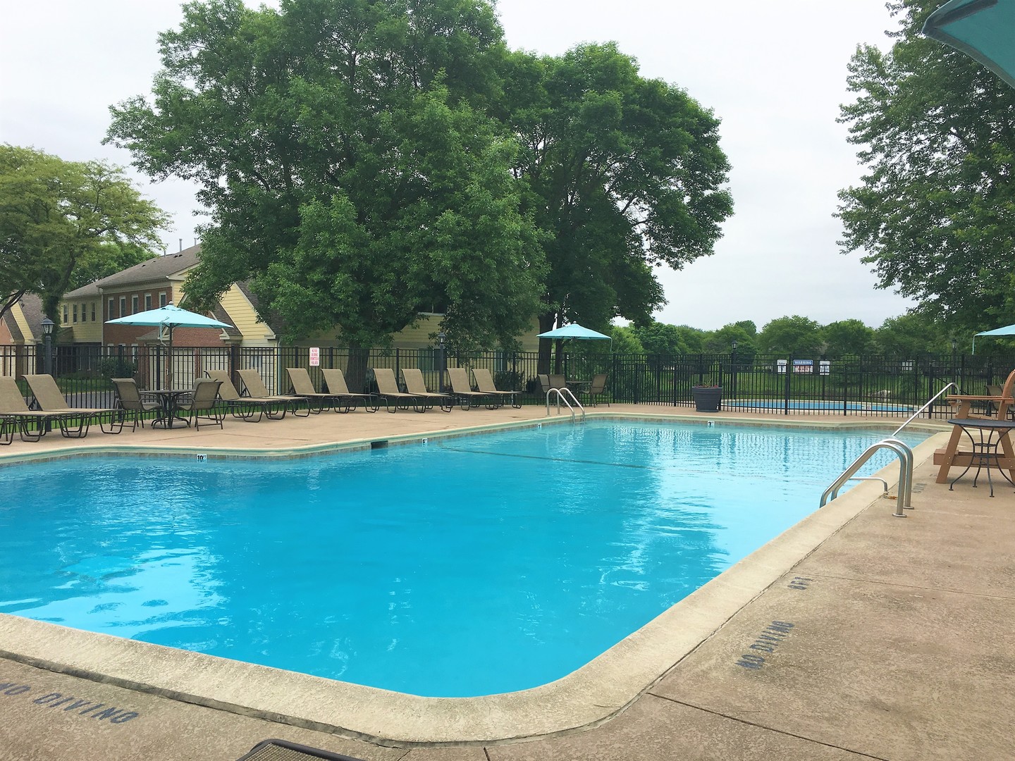 1410 Tulip Court, Unit D2 Wheeling, IL 60090 - Photo 28 of 30 a view of a swimming pool with a lake view