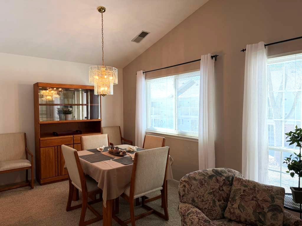 1410 Tulip Court, Unit D2 Wheeling, IL 60090 - Photo 5 of 30 a view of a dining room with furniture window and outside view