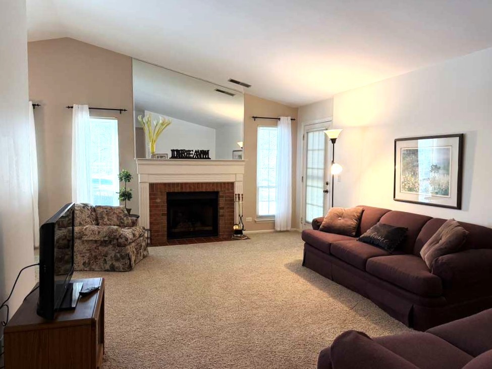 1410 Tulip Court, Unit D2 Wheeling, IL 60090 - Photo 6 of 30 a living room with furniture and a fireplace