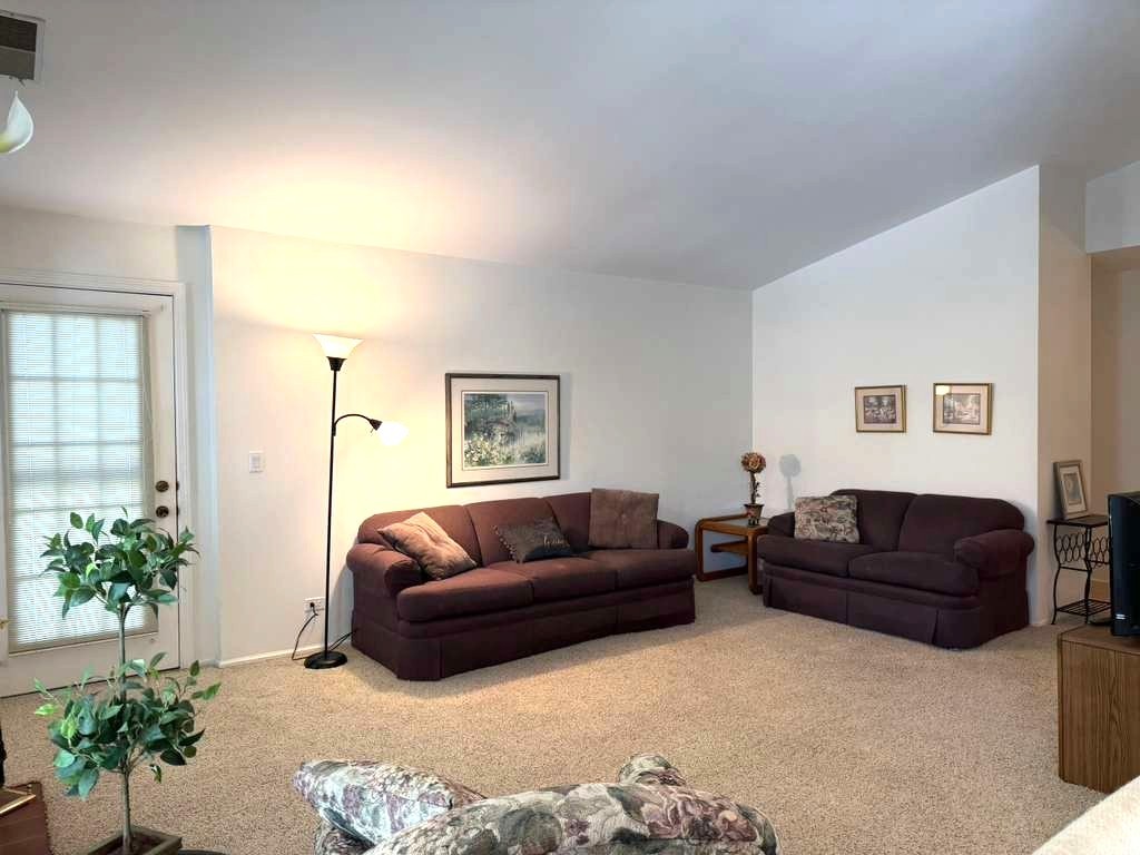 1410 Tulip Court, Unit D2 Wheeling, IL 60090 - Photo 7 of 30 a living room with furniture and a couch