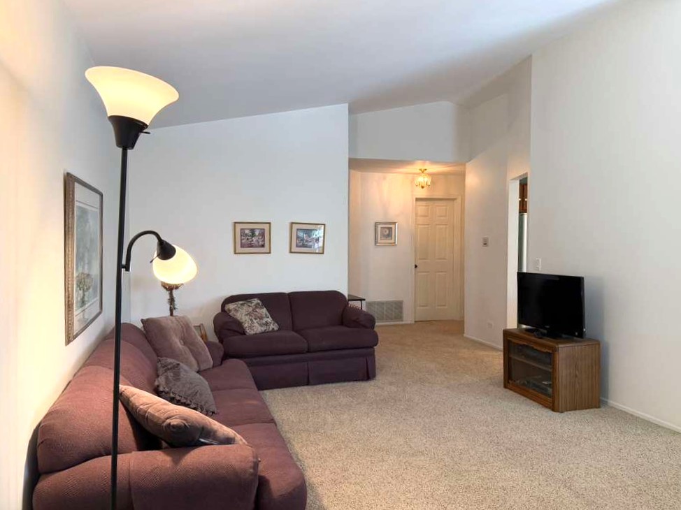1410 Tulip Court, Unit D2 Wheeling, IL 60090 - Photo 8 of 30 a living room with furniture and a flat screen tv
