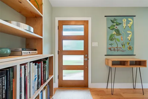 a view of an entryway with wooden floor