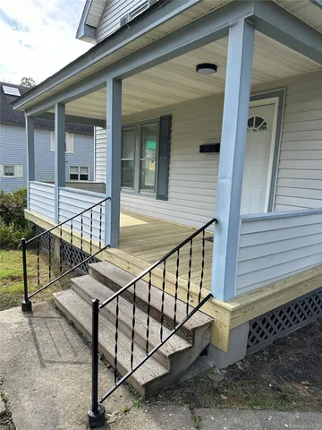 a view of house with outdoor seating and stairs