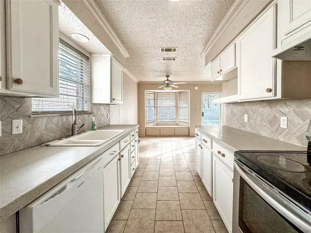 a kitchen with a sink stove and cabinets