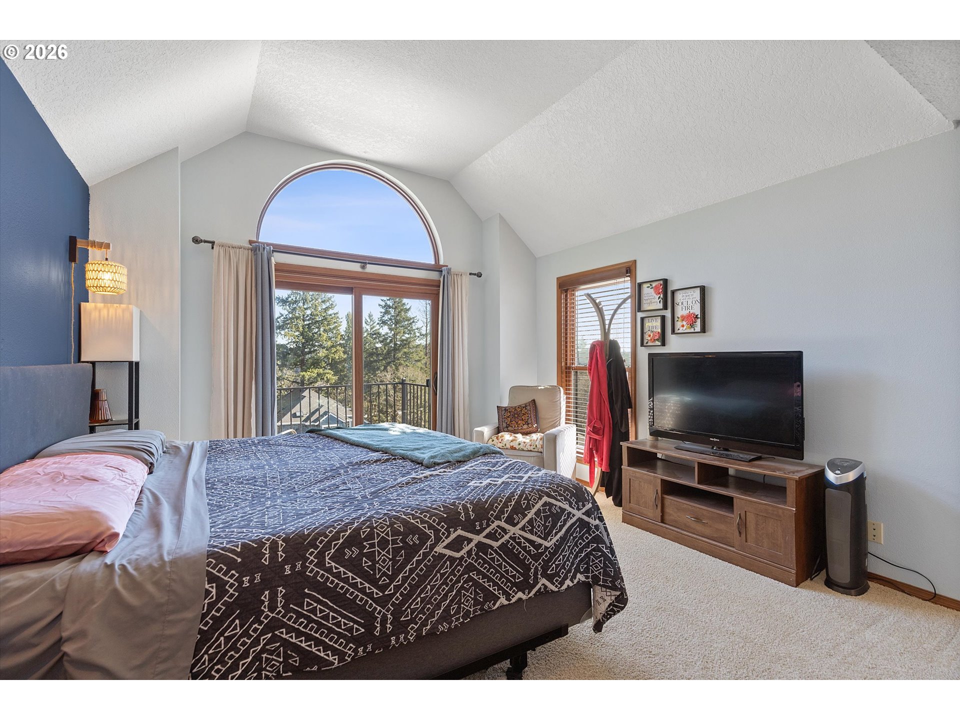 7655 Ridgewood Drive Gladstone, OR 97027 - Photo 15 of 27 a bedroom with a bed and a flat screen tv
