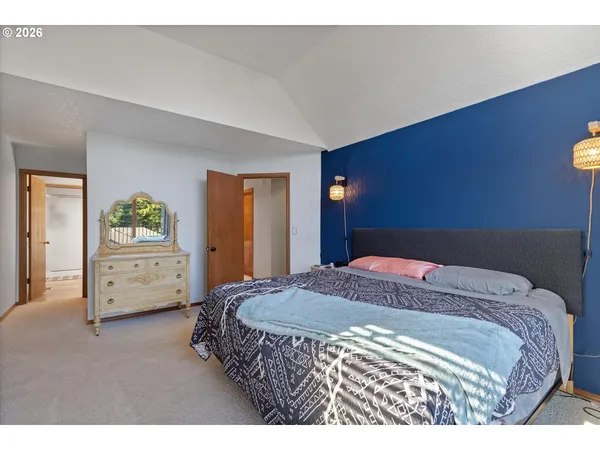 a bedroom with a bed and a dresser