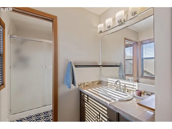 a bedroom with a bed and a mirror