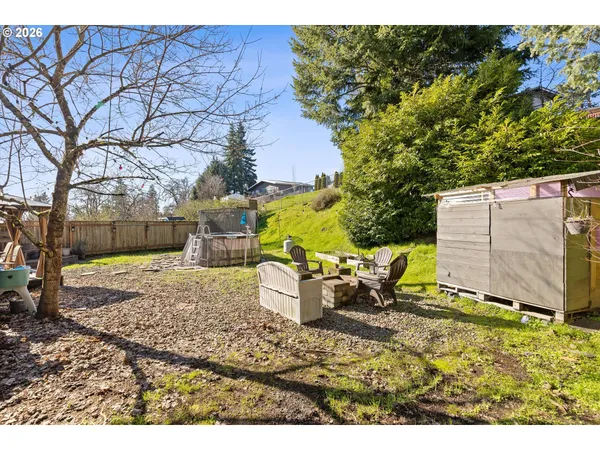 a view of a backyard with wooden fence
