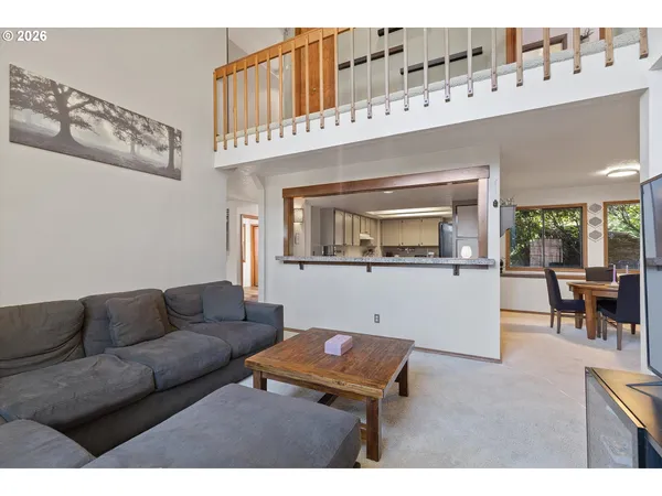a living room with furniture and painting on the wall
