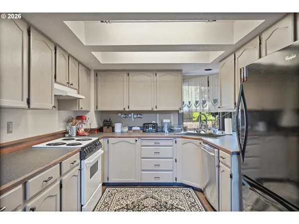 a kitchen with a sink cabinets and window