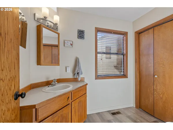 a bathroom with a sink a mirror and a shower
