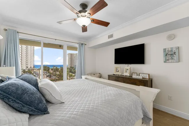 a bedroom with a bed tv and a window