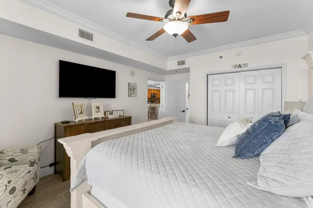 a bedroom with a large bed and a flat screen tv