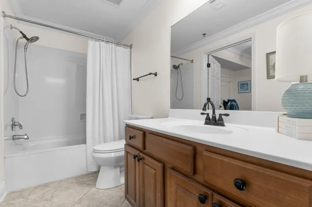 a bathroom with a granite countertop sink a toilet and a bathtub