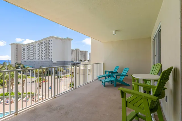 a balcony with chairs and a table