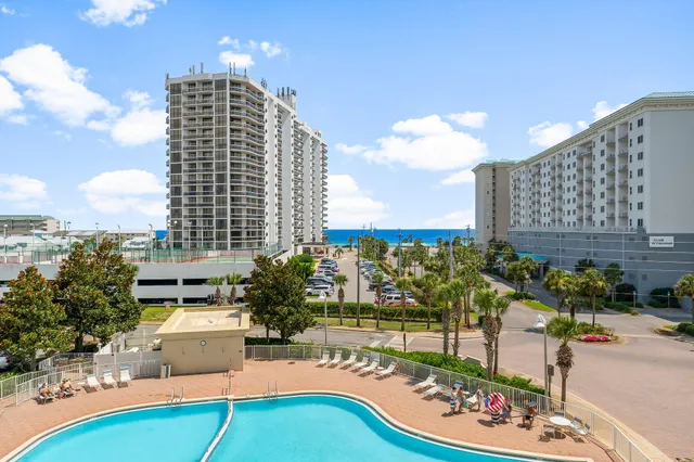a aerial view of a multi story parking building with yard and outdoor seating