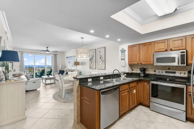 a kitchen with a stove sink cabinets and microwave