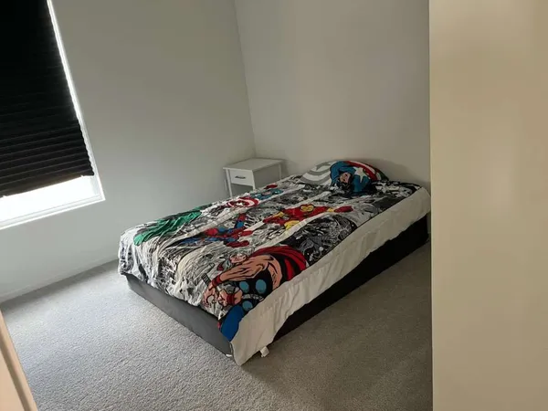 a bed sitting in a bedroom next to a window