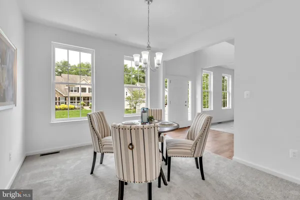 a view of a dining room with furniture window and outside view