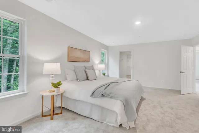 a bedroom with a bed and a night stand