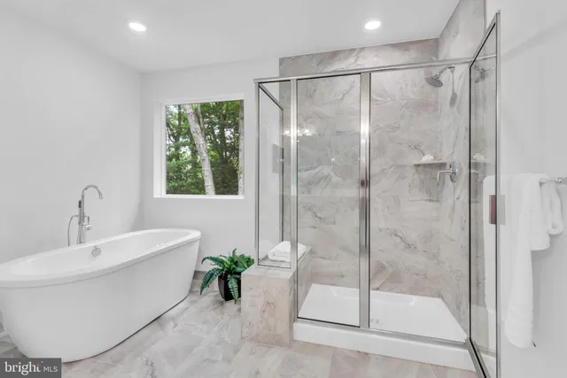 a bathroom with a bathtub and a shower