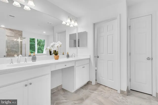 a bathroom with a double vanity sink and a mirror
